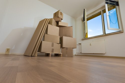 A van moving team using safe manual handling on a property staircase