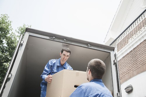 Removalists carrying furniture through a Chingford property