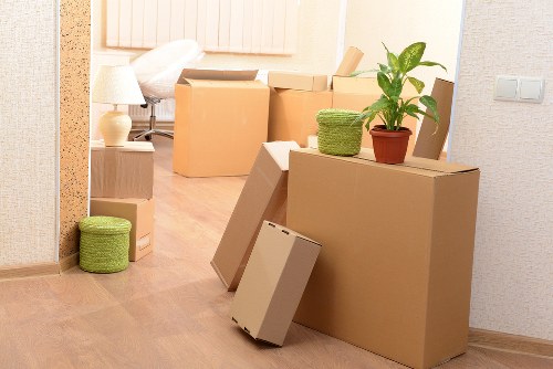 Professional movers carrying furniture through a residential street